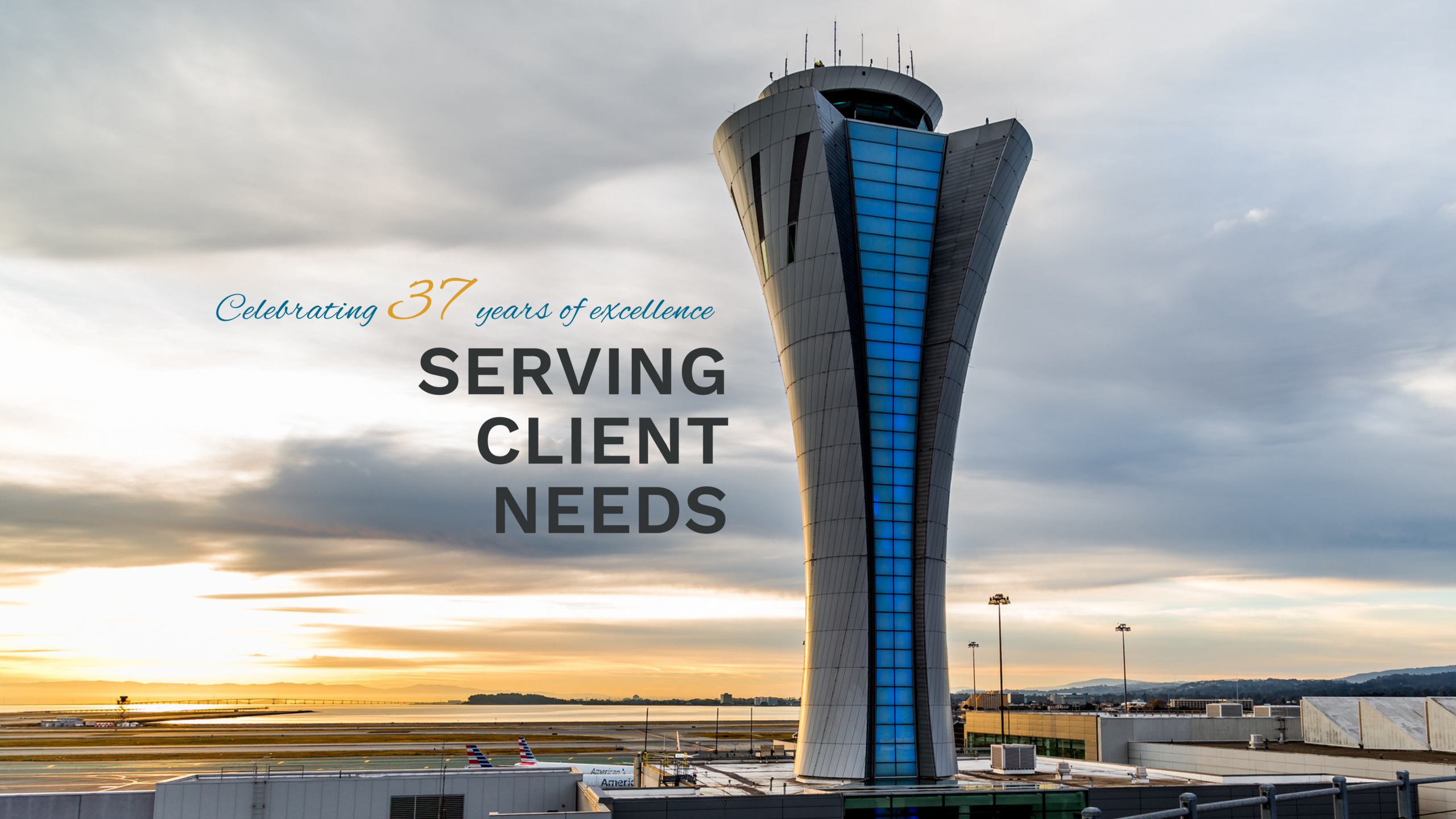 Image of the Air Traffic Control Tower at the San Francisco International Airport. Text on the left side of the image reads: "Celebrating 36 years of excellence" and "Serving Client Needs."